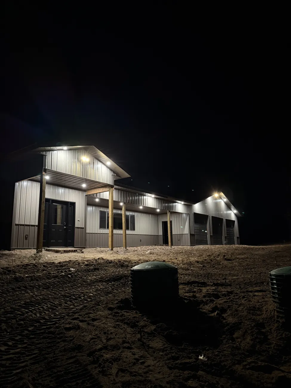 New metal shop building at night with soffit lighting running the length of the eaves